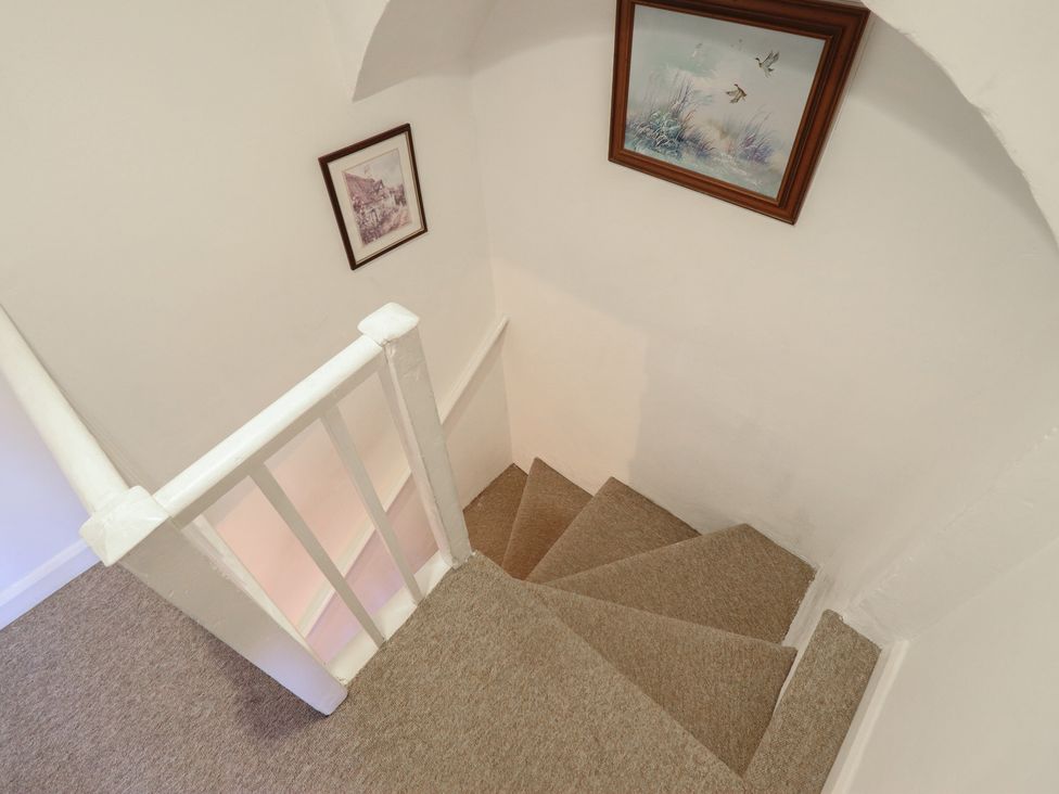 A staircase with carpet and framed pictures at 32 Crescent Street Newtown
