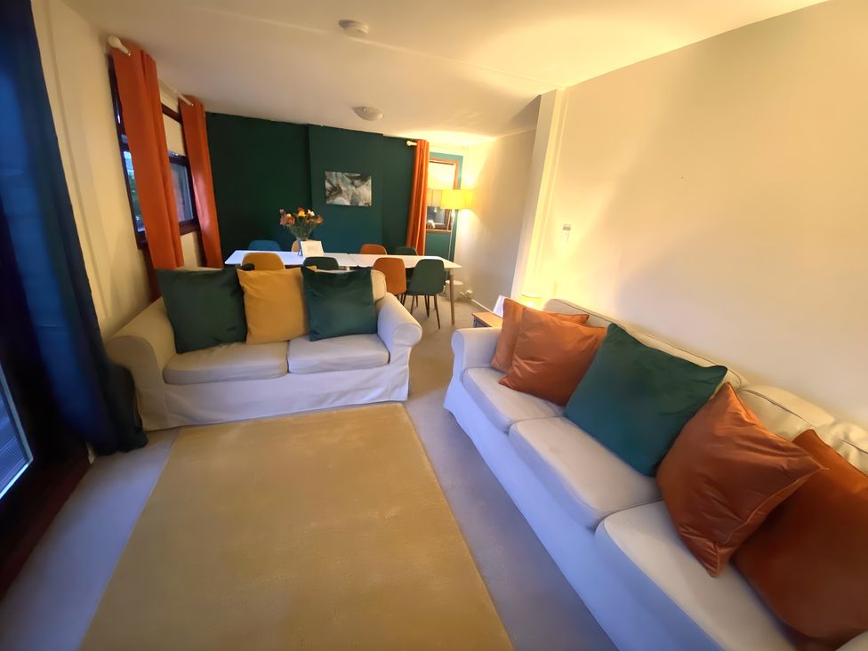 A living room with couches and dining area at Cabin 1 Moffat Manor in Moffat