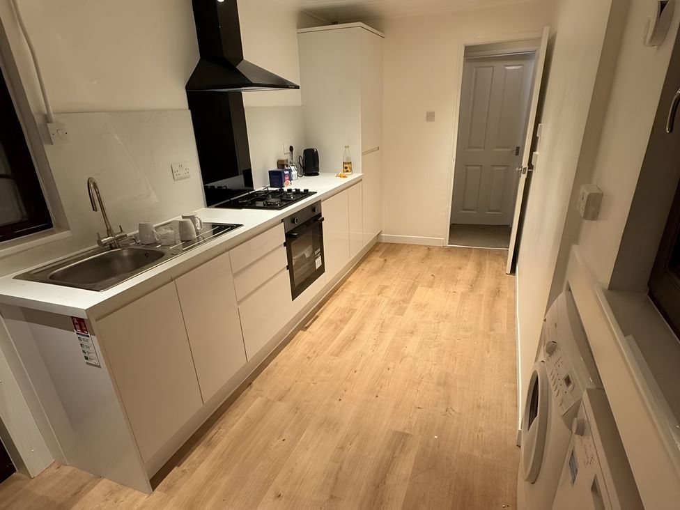 A kitchen with a sink and stove in Cabin 1 Moffat Manor Moffat