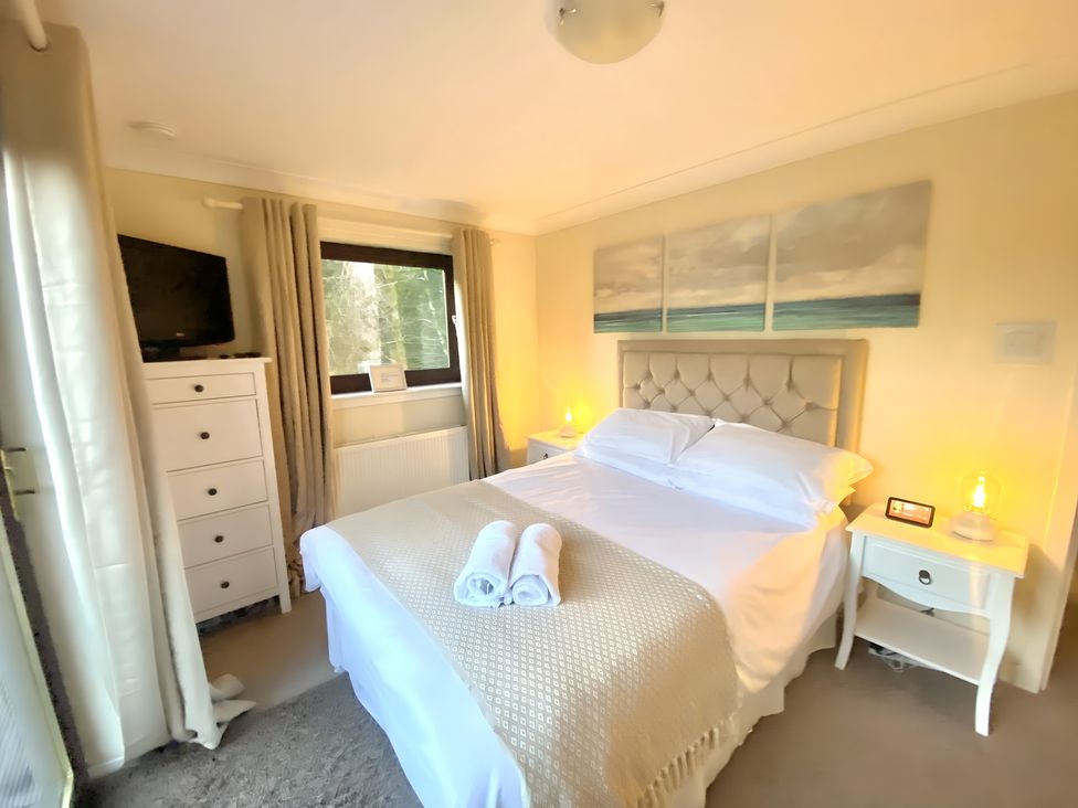 A bedroom with a bed and dresser at Cabin 1 Moffat Manor in Moffat