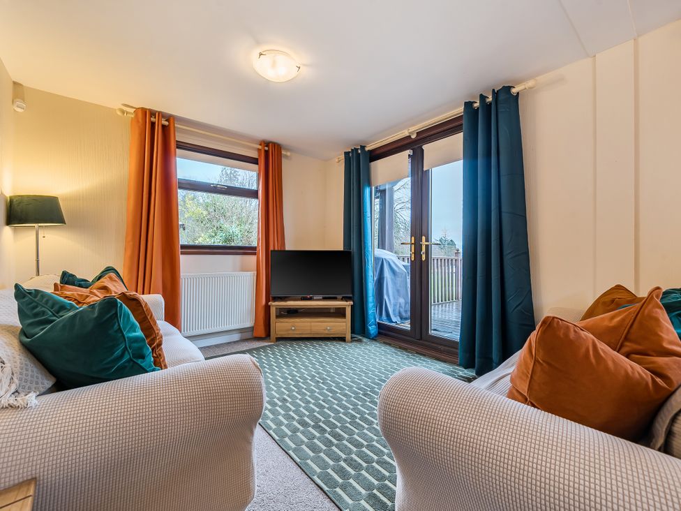 A living room with a television and sofa at Cabin 1 Moffat Manor Beaufort