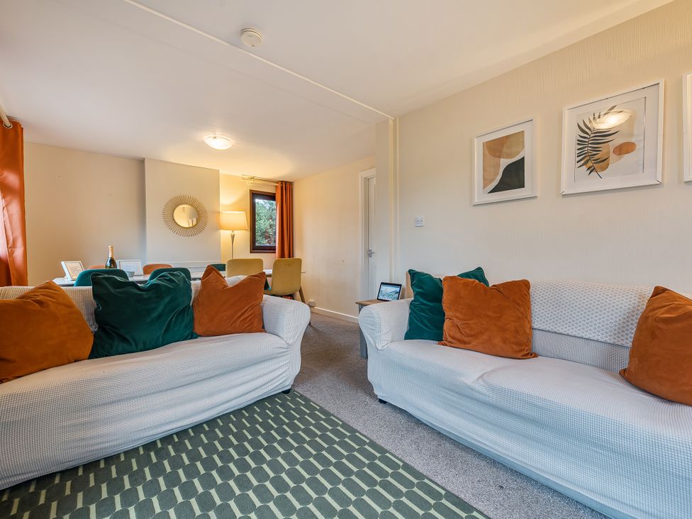 A living room with sofas and a table at Cabin 1 Moffat Manor in Beaufort