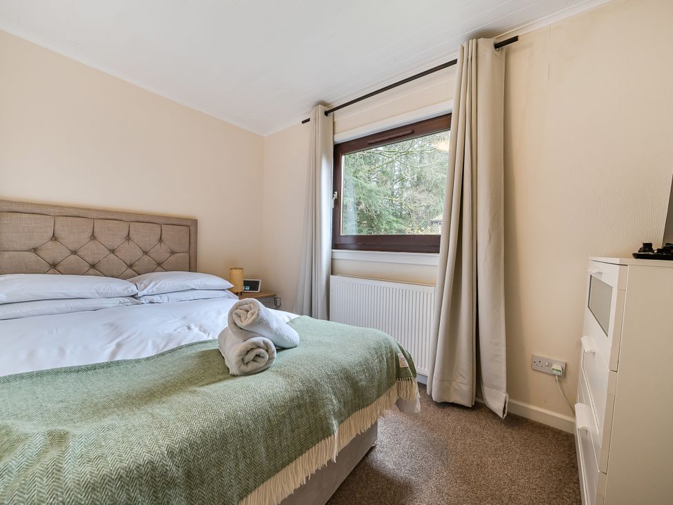 A bedroom with a bed and window at Cabin 1 Moffat Manor in Beaufort