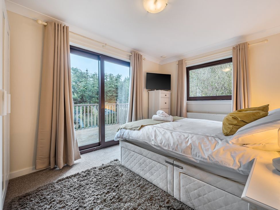 A bedroom with a bed and television at Cabin 1 Moffat Manor, Beaufort