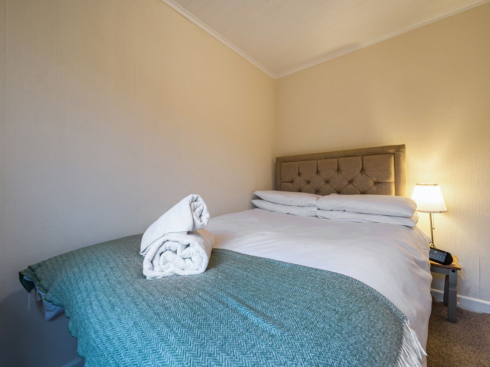 A bedroom with a bed and towels at Cabin 1 Moffat Manor in Beaufort