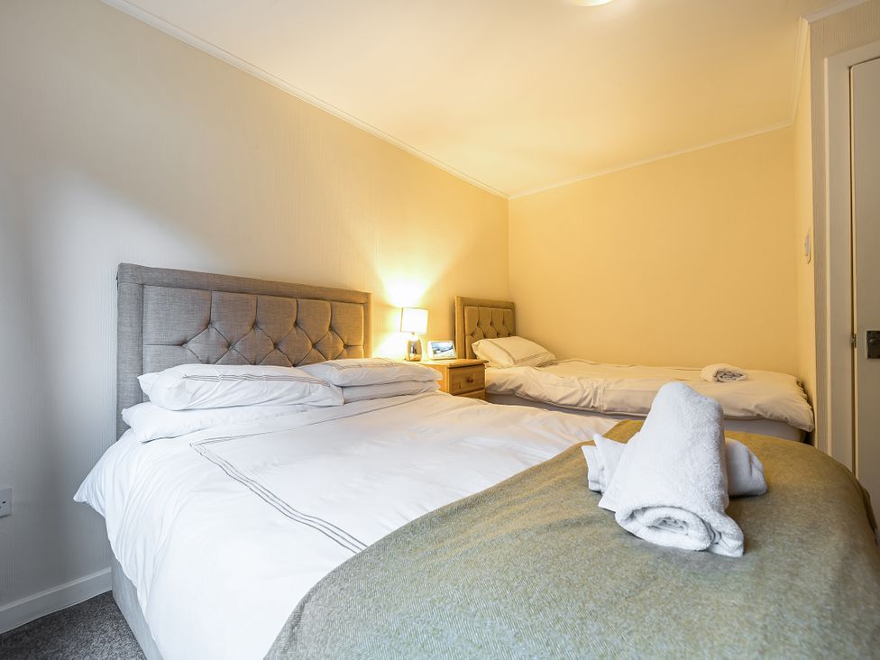 A bedroom with two beds and a nightstand at Cabin 1 Moffat Manor Beaufort