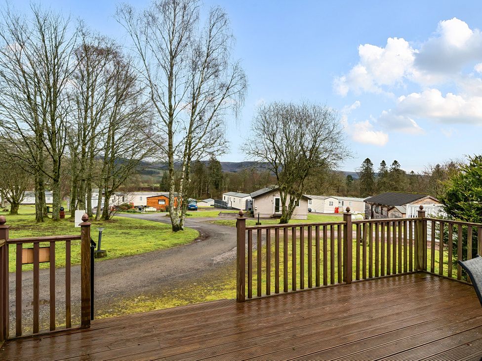 An outdoor view from a deck overlooking caravans and trees at Cabin 1 Moffat Manor Beaufort