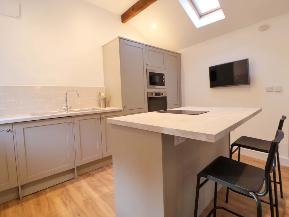 A kitchen with a sink, countertop, and appliances at The Apple Store in Tarporley