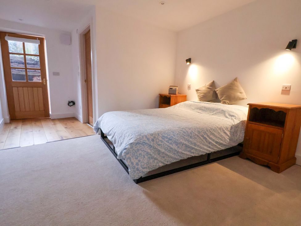 A bedroom with a bed and nightstands at The Apple Store in Tarporley
