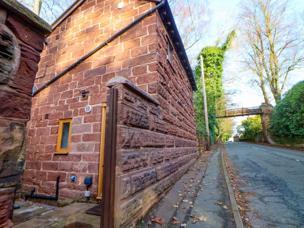 An exterior view of a stone building with a window and door at The Apple Store in Tarporley