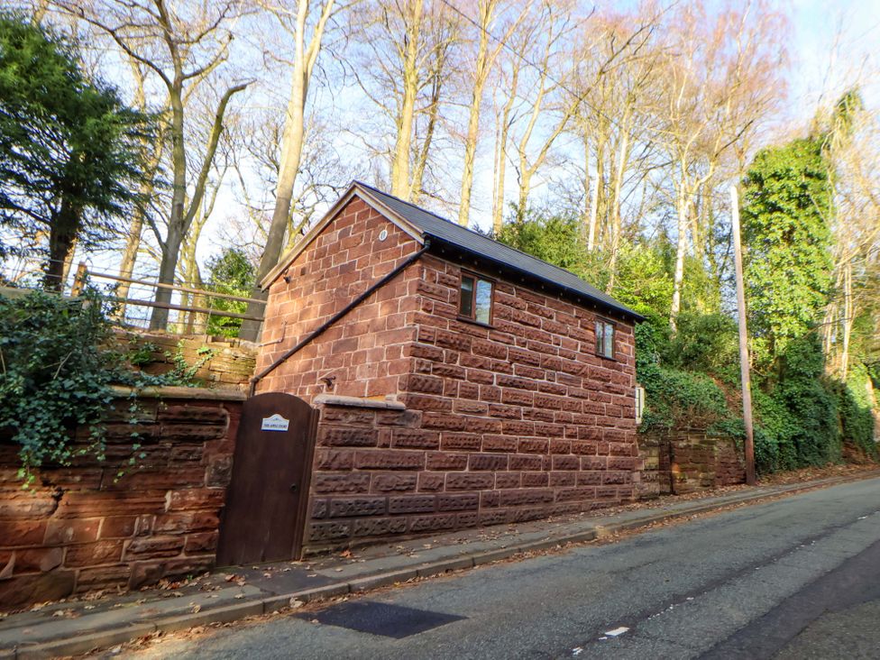 A small building with a door and windows near a road at The Apple Store in Tarporley