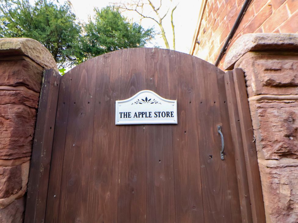 A wooden gate with a sign reading The Apple Store in Tarporley