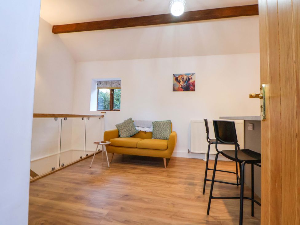 A living room with a couch and a table at The Apple Store in Tarporley