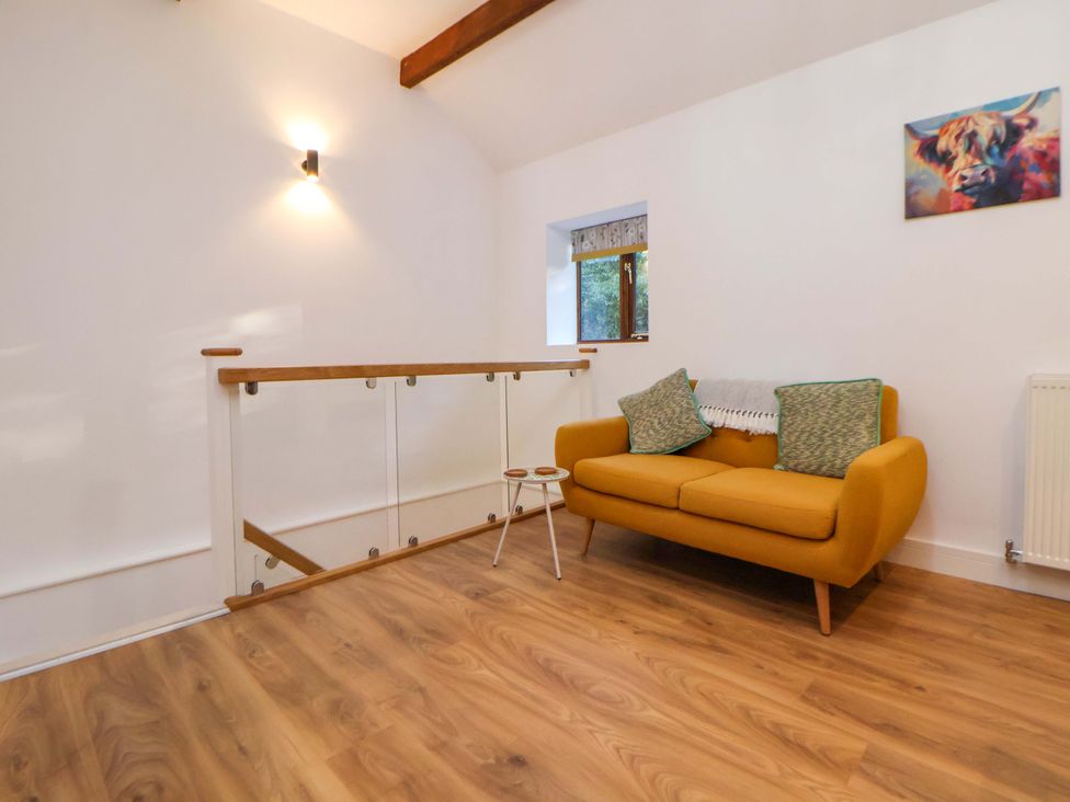A snug area with a sofa and table at The Apple Store in Tarporley