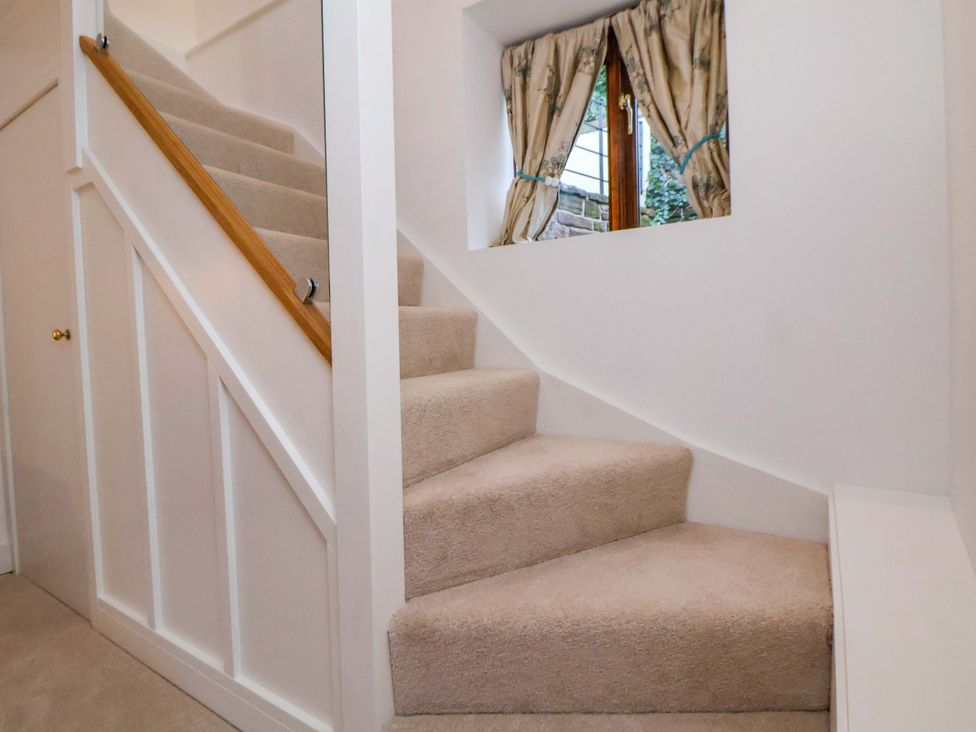 Stairs leading to an upper floor with a window at The Apple Store in Tarporley