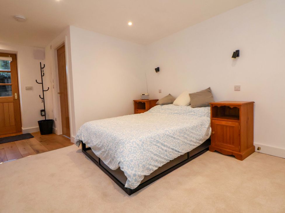 A bedroom with a bed and bedside tables at The Apple Store in Tarporley