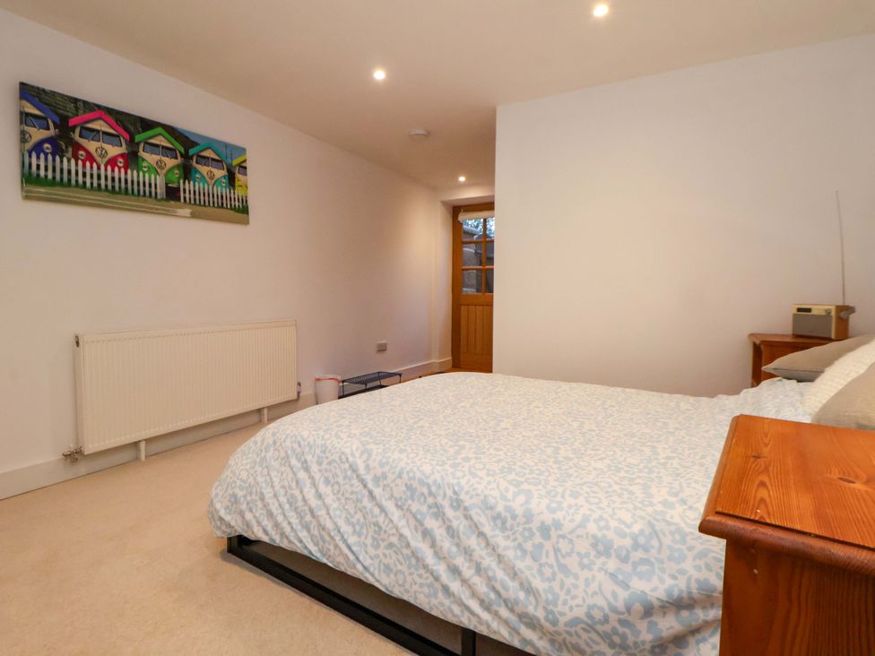 A bedroom with a bed and radiator at The Apple Store in Tarporley