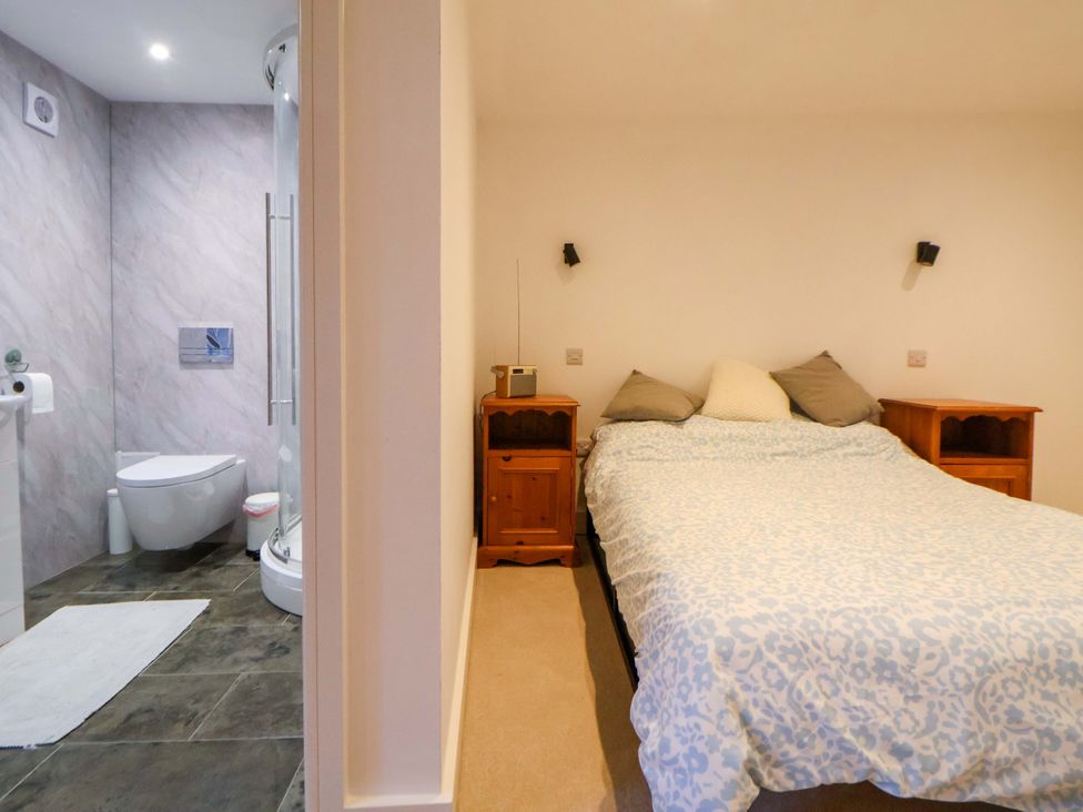 A bedroom with a bed and adjoining bathroom area at The Apple Store in Tarporley