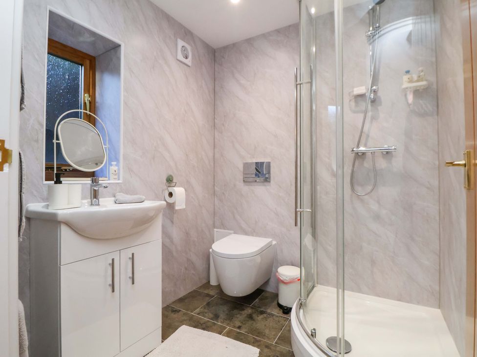 A bathroom with a shower and sink at The Apple Store in Tarporley