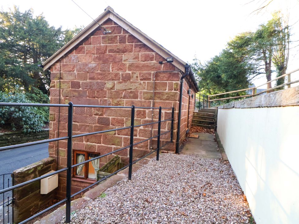 An outdoor view of a building with steps and a fence at The Apple Store in Tarporley