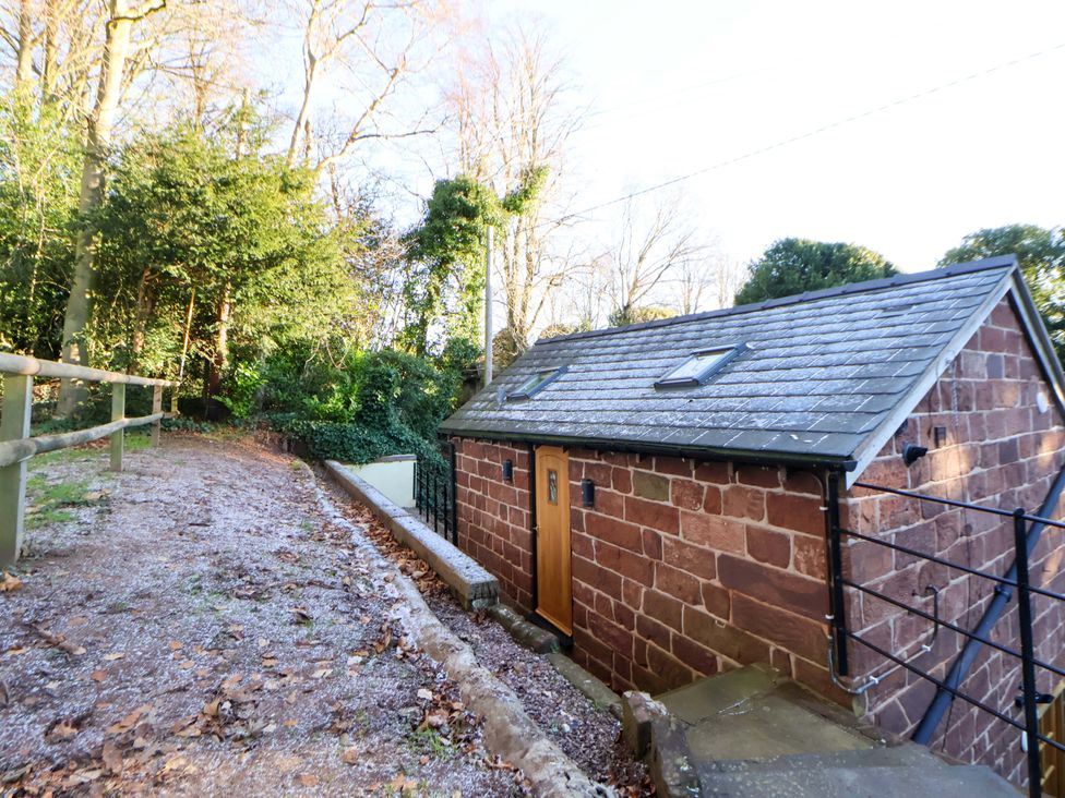 An outdoor view of a building with trees and a pathway at The Apple Store in Tarporley