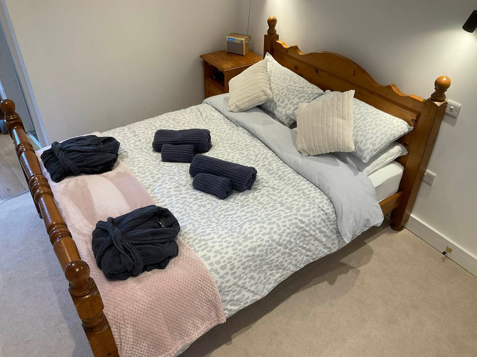 A bedroom with a bed and bedside table at The Apple Store in Tarporley