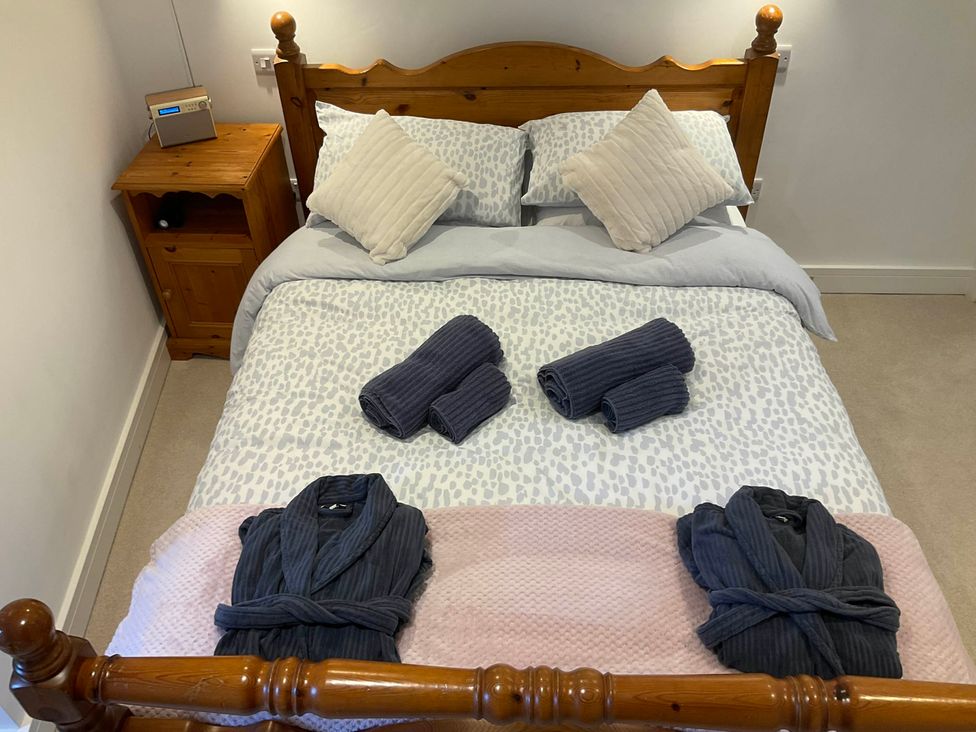 A bedroom with bed and nightstand at The Apple Store in Tarporley
