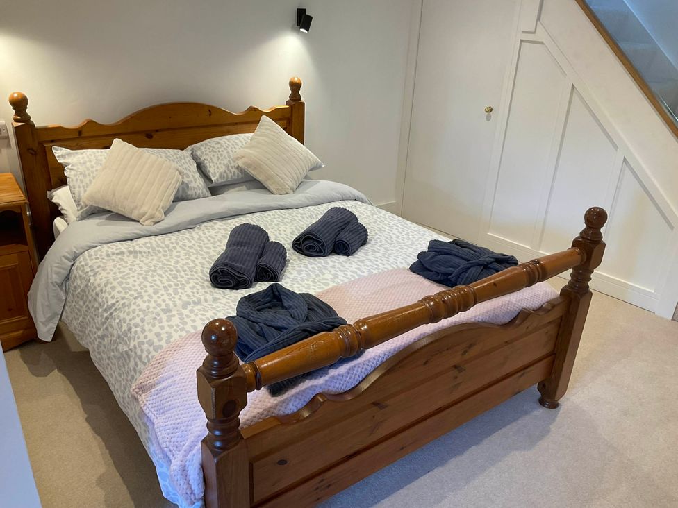 A bedroom with a bed and towels arranged at The Apple Store in Tarporley