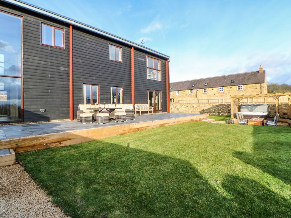 An outdoor view of a house with a garden at Stackyard, Durham