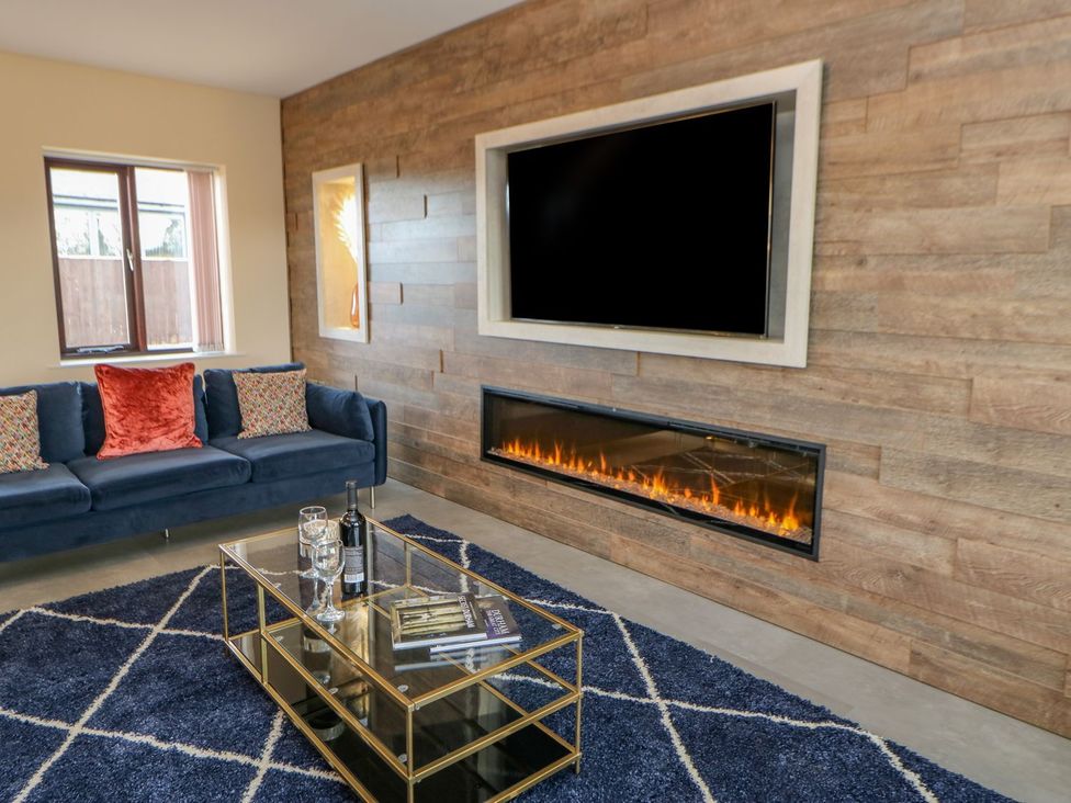 A living room with a television and fireplace at Stackyard in Durham
