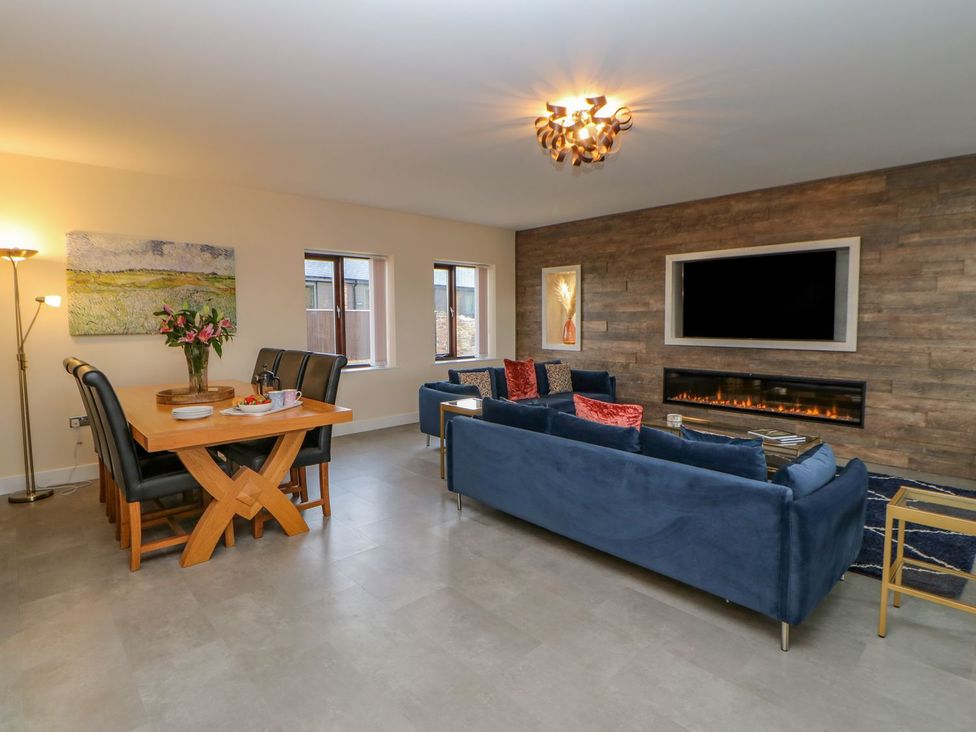 A living room with a sofa and dining area at Stackyard in Durham