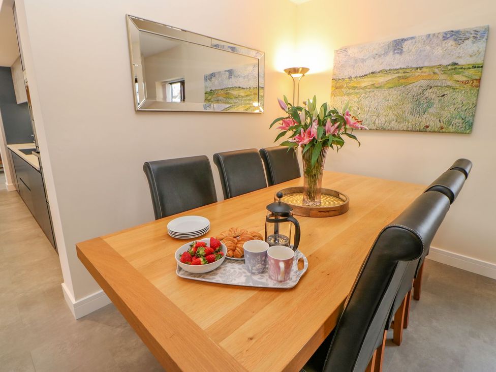 A dining room with a wooden table and chairs at Stackyard in Durham