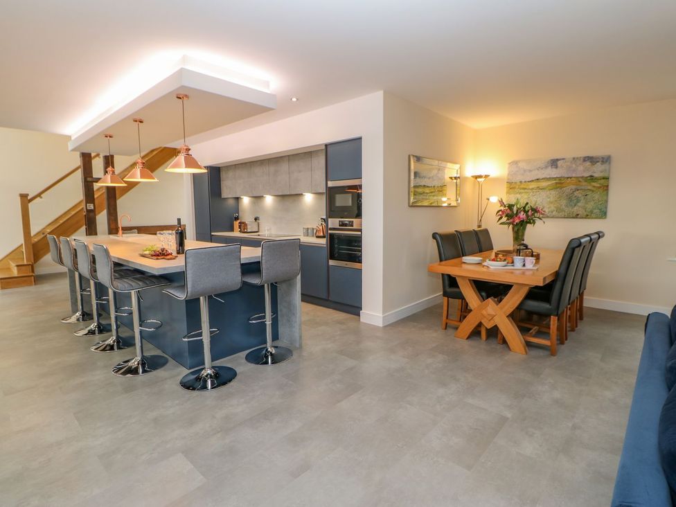 A kitchen with island seating and dining area at Stackyard in Durham