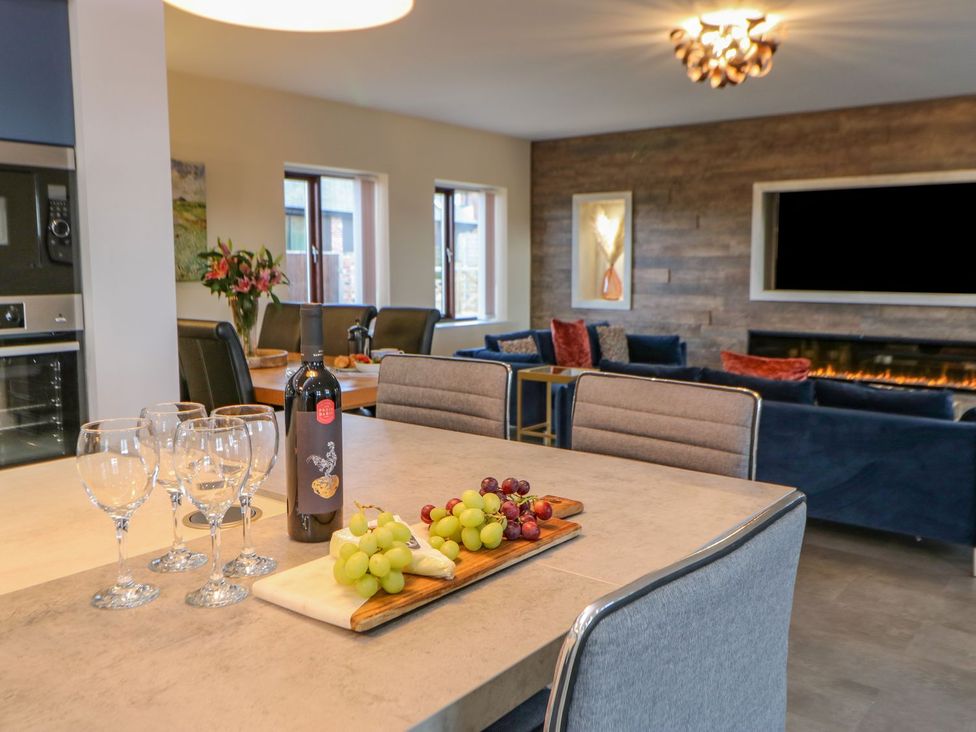 A kitchen with wine glasses and grapes on a table at Stackyard in Durham