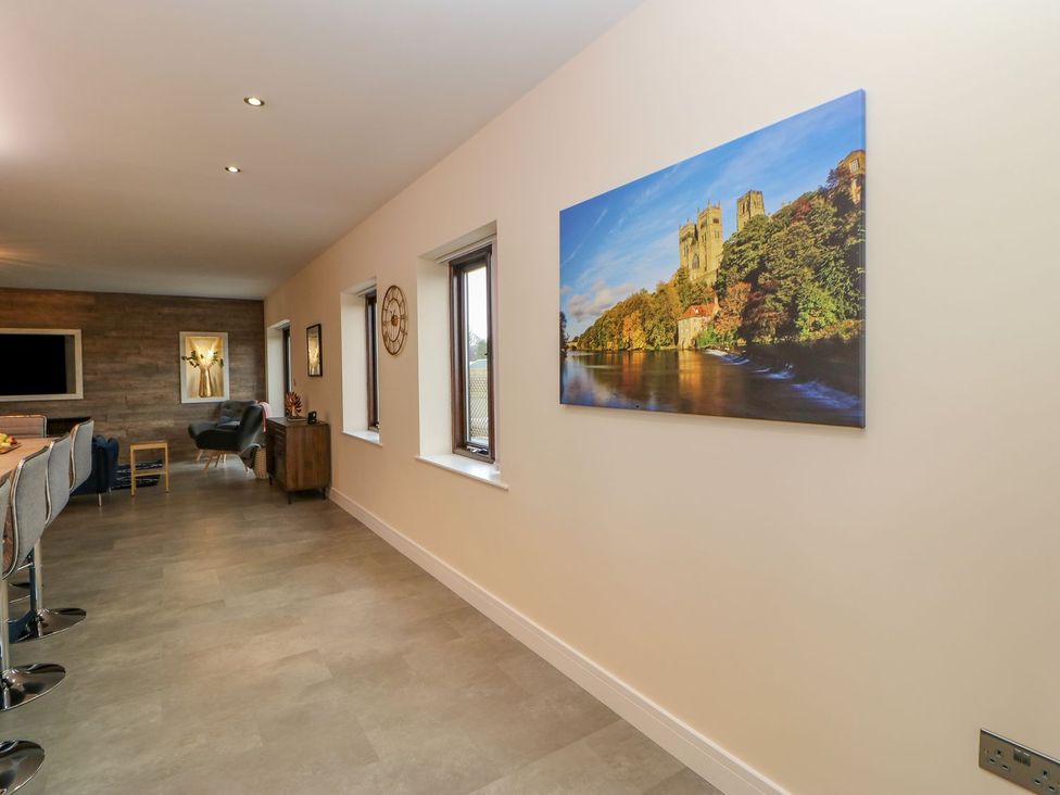 A kitchen with bar stools and a view of a landscape at Stackyard in Durham