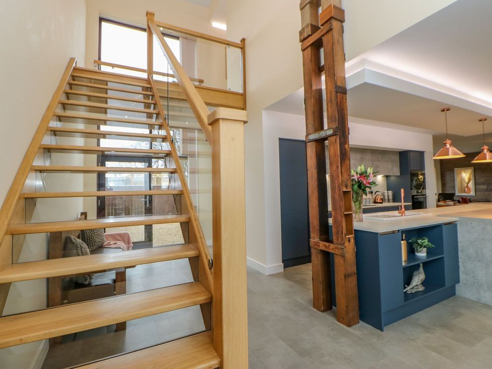 An entryway with a staircase and open kitchen area at Stackyard in Durham