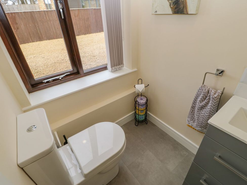 A bathroom with a toilet and sink at Stackyard Durham