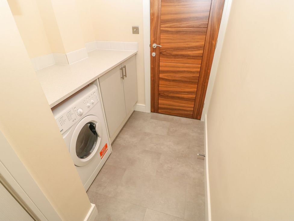 A laundry room with a washing machine and countertop at Stackyard in Durham