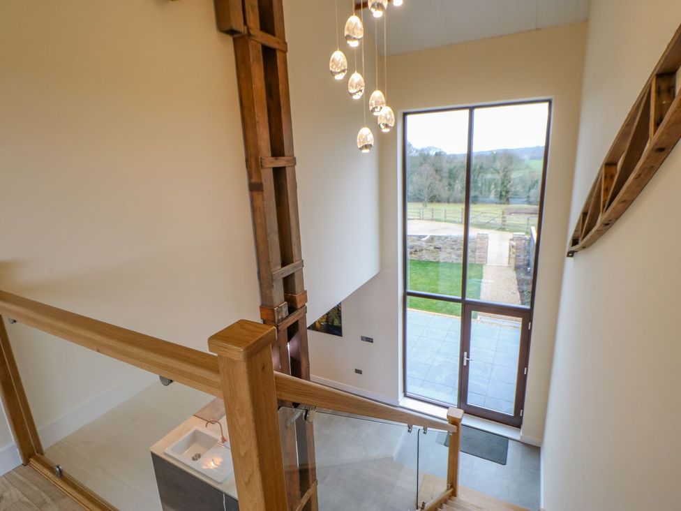 A hallway with a staircase and large windows at Stackyard in Durham