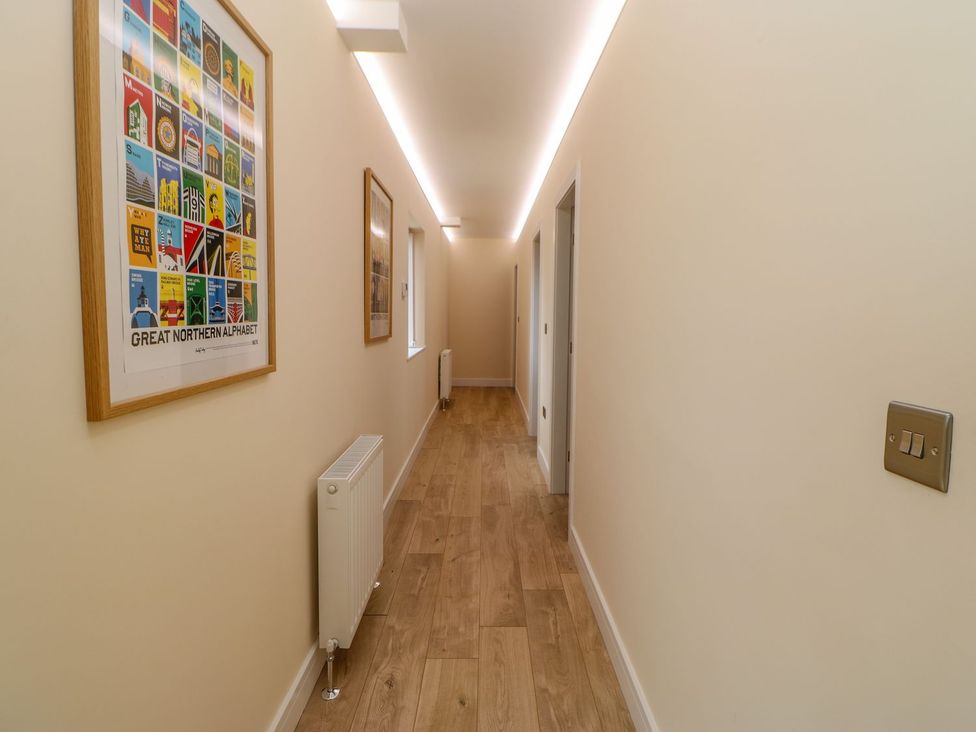 A hallway with artwork and a radiator at Stackyard, Durham