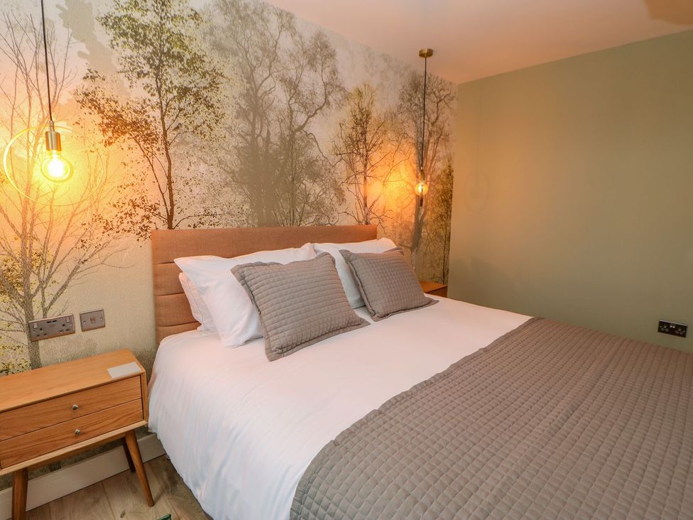 A bedroom with a bed and bedside table at Stackyard in Durham