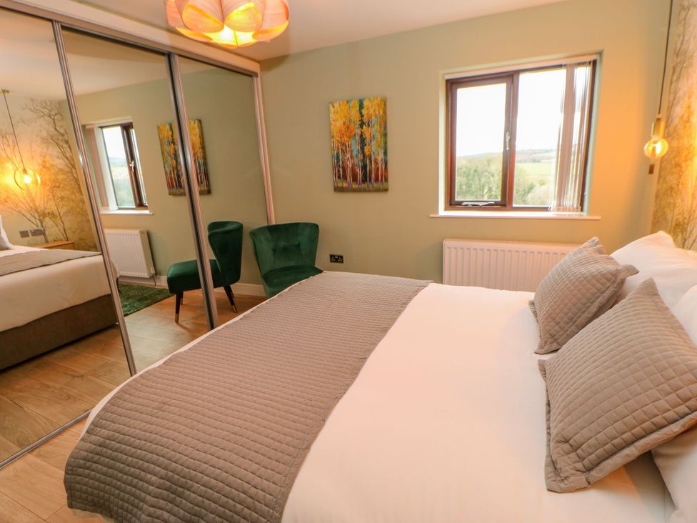 A bedroom with a bed and chairs at Stackyard in Durham