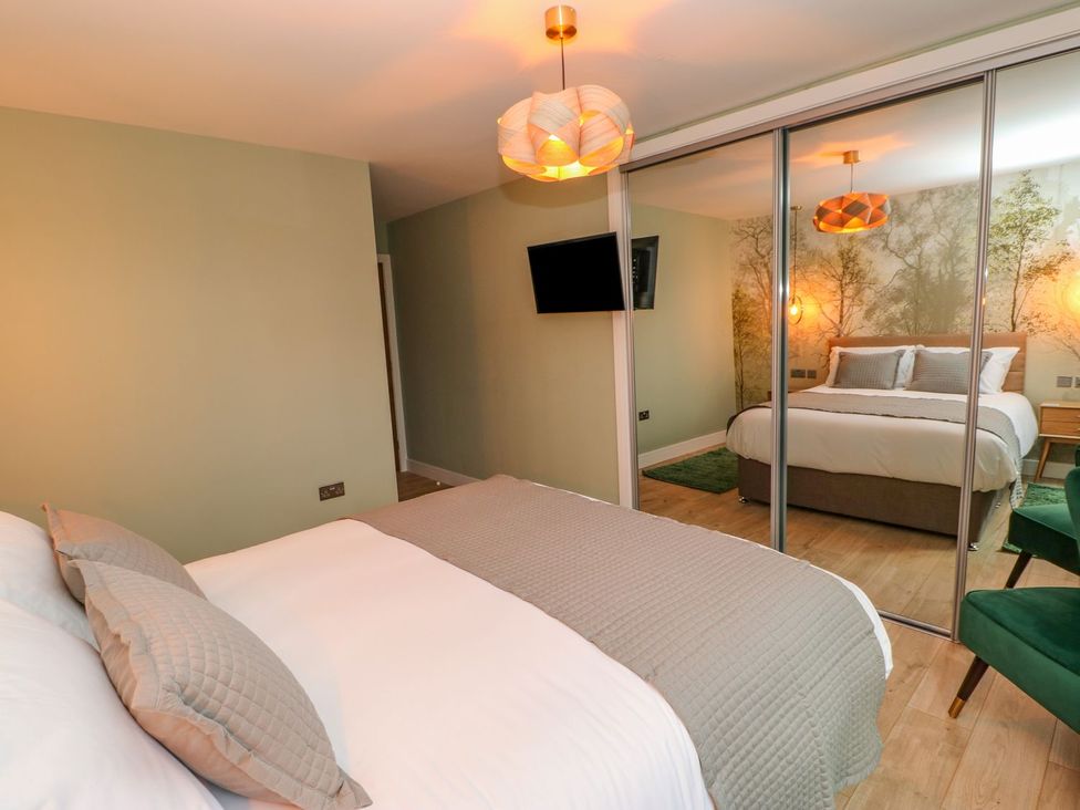 A bedroom with a bed and television at Stackyard in Durham