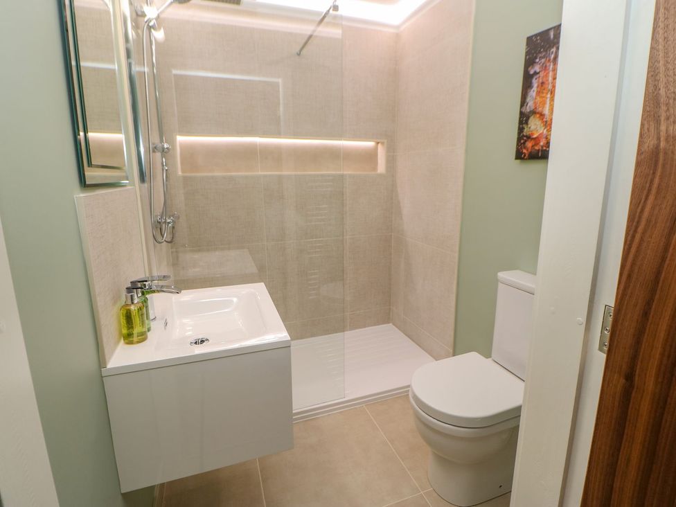 A bathroom with a shower, sink and toilet at Stackyard in Durham