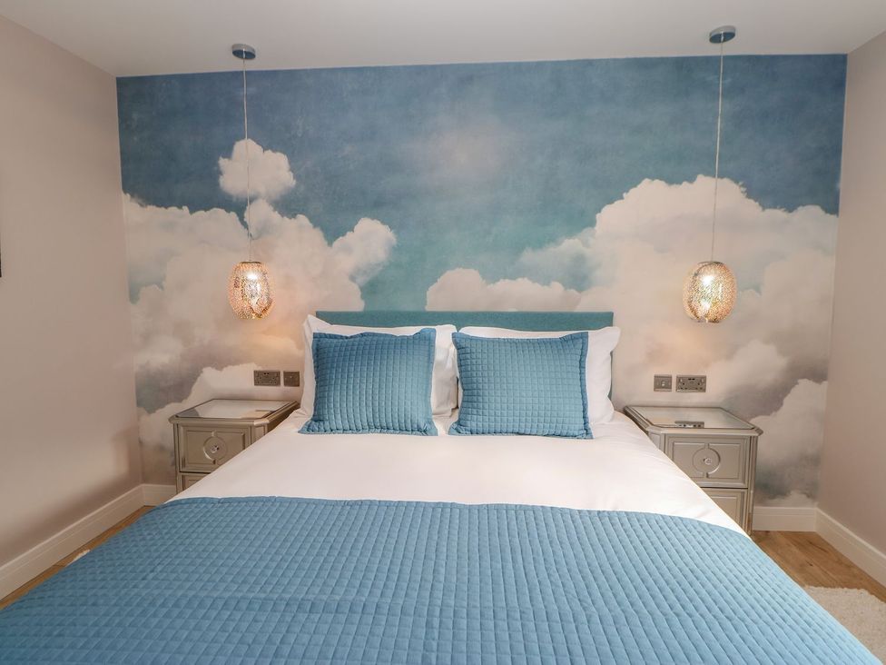 A bedroom with a bed and bedside tables at Stackyard in Durham