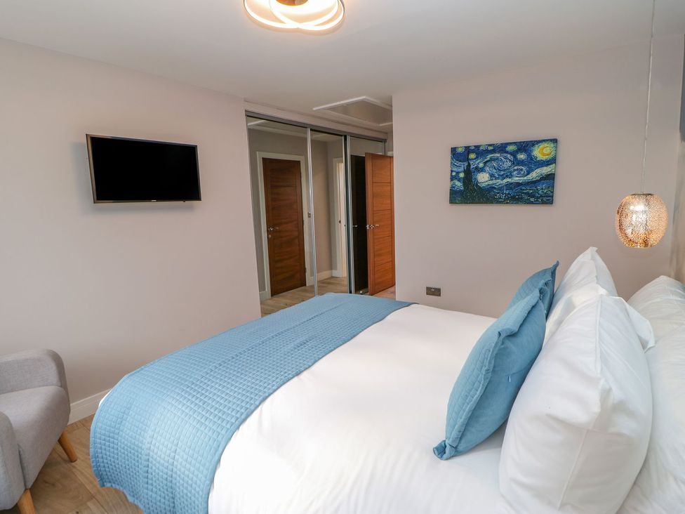 A bedroom with a bed and television at Stackyard in Durham