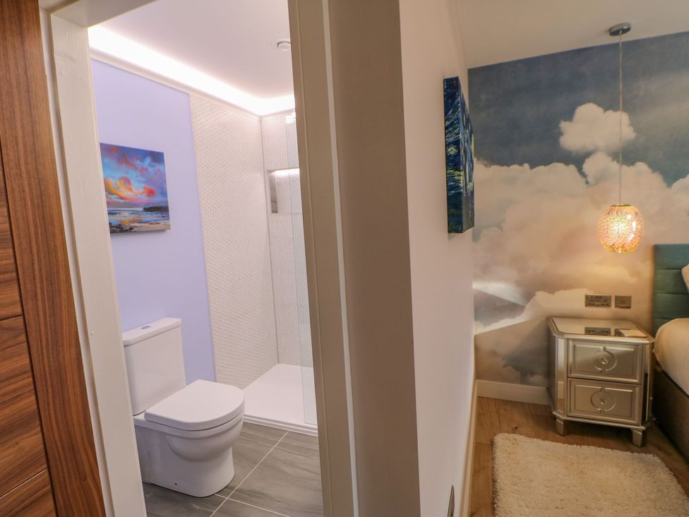 A bathroom with a toilet and shower visible at Stackyard in Durham