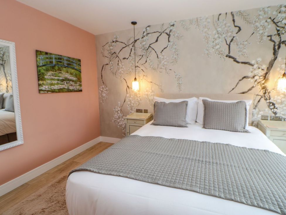A bedroom with a bed and wall art at Stackyard in Durham