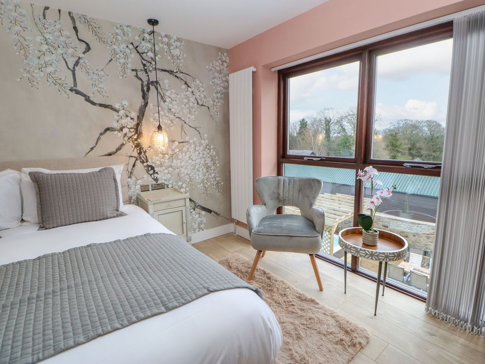 A bedroom with a bed and chair at Stackyard in Durham