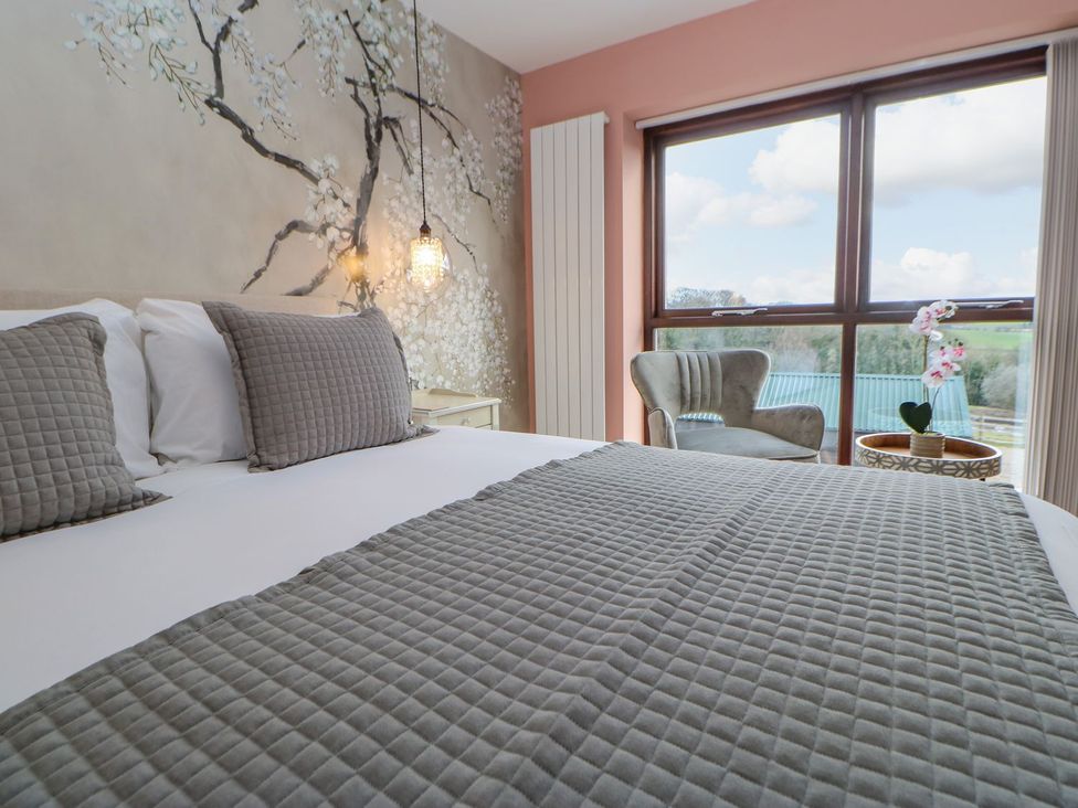 A bedroom with a bed and a chair at Stackyard in Durham